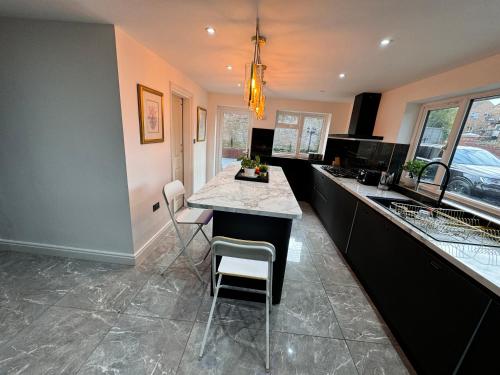 a kitchen with a island with a counter top at Lux 7 Bedroom residence in Waterlooville