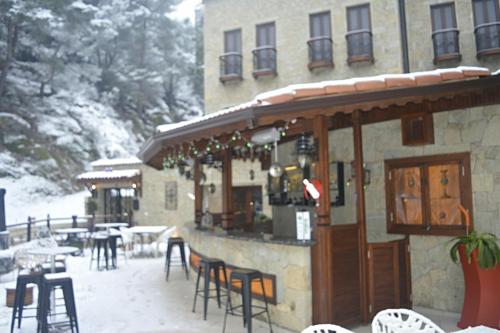 a restaurant with tables and chairs in the snow at Kazdaglari Karye Müze Hotel in Kucukkuyu