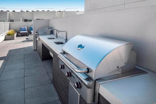 a kitchen with a sink and a counter in a room at Sky-Rise Apartments in Los Angeles