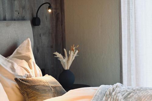 a bedroom with a bed with a pillow and a window at ALOHA Suites - Alp LOdge HAus in Haus im Ennstal