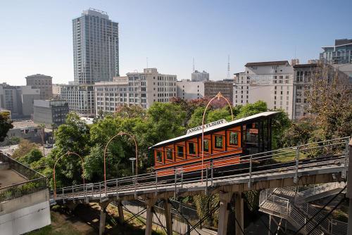 an orange train on a bridge in a city at Sky-Rise Apartments in Los Angeles
