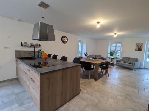 une cuisine et un salon avec une table et une salle à manger dans l'établissement Maison chaleureuse avec Wifi à Sainte-Barbe - FR-1-589-753, à Sainte-Barbe