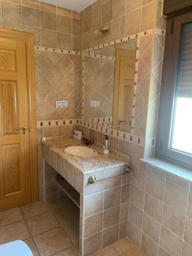 a bathroom with a sink and a mirror at Casa Rural Los Tasajos in La Horcajada