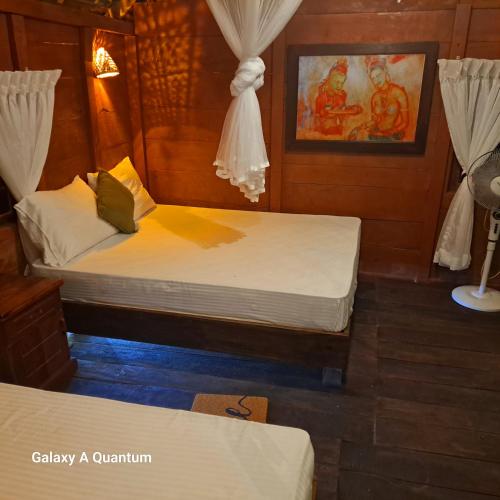 a couple of beds in a room at Green leaf Tree house in Dambulla
