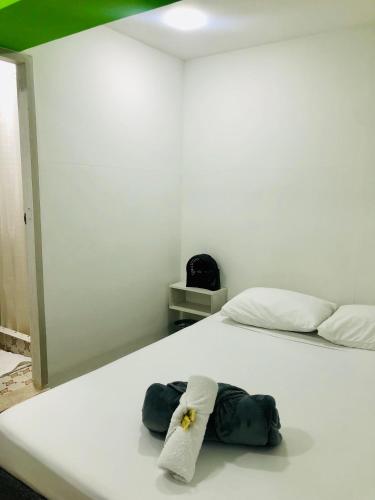a white bed with a towel sitting on it at Hotel Café Color in Armenia