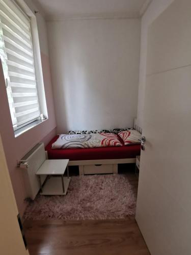 a small bedroom with a bed and a window at Apartment Armando in Liezen