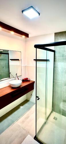 a bathroom with a sink and a glass shower at Villa Biju in Jericoacoara
