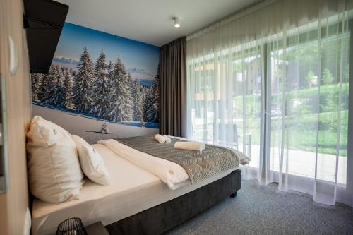 Katil atau katil-katil dalam bilik di Malino Resort & Residences - Ski and Bike Apartments
