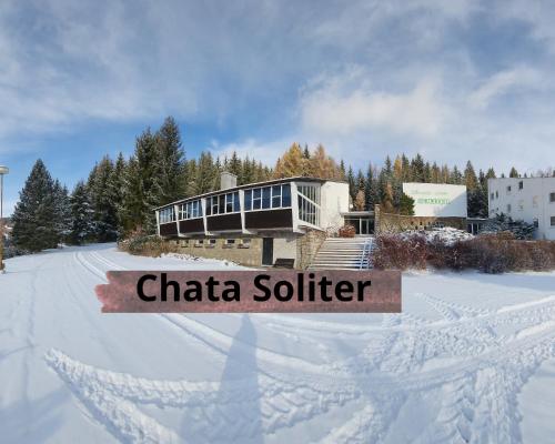a house in the snow with a sign that reads charia soldier at Chaty Malá Morávka in Bruntál