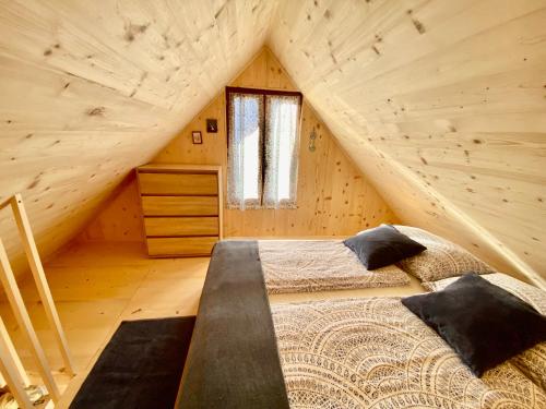a bedroom with two beds in a wooden cabin at Sweet Bee Cottage in Bovec