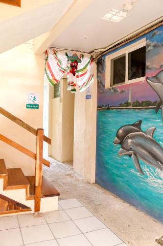a dolphin mural on the wall of a room at Hotel Rosa del Alba, Malecón Chetumal in Chetumal