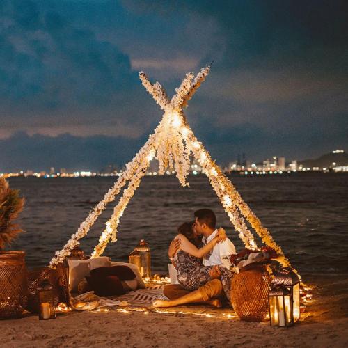 a couple sitting on the beach under a star at Fenix Beach Cartagena in Tierra Bomba