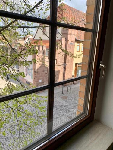 a window with a view of a street outside at Helle geräumige Altstadtwohnung am Hagentor in Neuhaldensleben