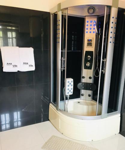 a mirror in a bathroom with a machine in it at Ama Villa Negombo in Negombo