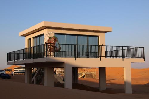 a house with a balcony in the desert at Oman desert private camp in Shāhiq