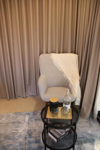 a living room with a chair and a coffee table at Oman desert private camp in Shāhiq