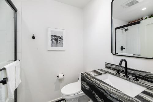 a bathroom with a sink and a mirror at The Brick Boutique Hotel in Oceanside