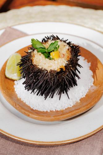 a plate of food with rice on a plate at Almareia Boutique Hotel in Praia dos Carneiros