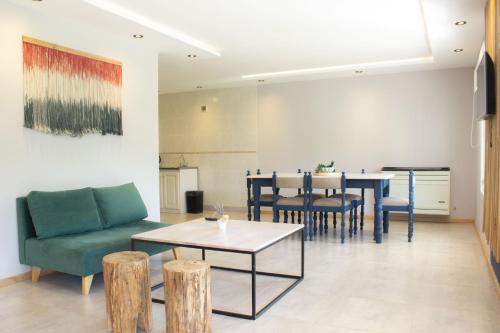 a living room with a couch and a table at Apart Hotel Jardín in El Calafate