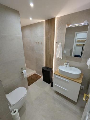 a bathroom with a white toilet and a sink at Cool Apartment in Znojmo