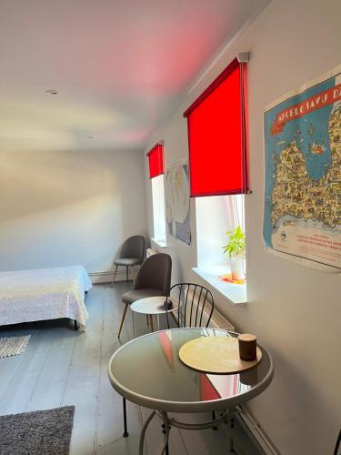 a room with a bed and a table and chairs at Piebalgas street apartment in Cesis in Cēsis
