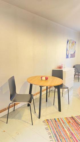 a dining room with a table and two chairs at Piebalgas street apartment in Cesis in Cēsis