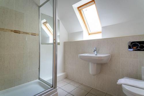 a bathroom with a sink and a shower at Farley, woodland lodge with hot tub for 8 in Oakamoor