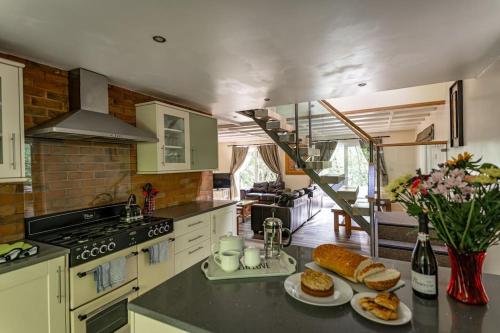 a kitchen with two plates of bread on a counter at Farley, woodland lodge with hot tub for 8 in Oakamoor