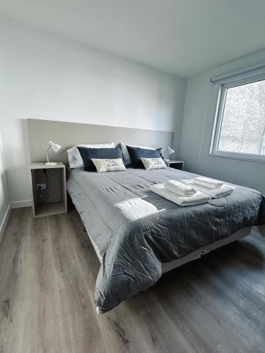 a bedroom with a large bed and a window at Gente del Sur - Gobernador Paz in Ushuaia