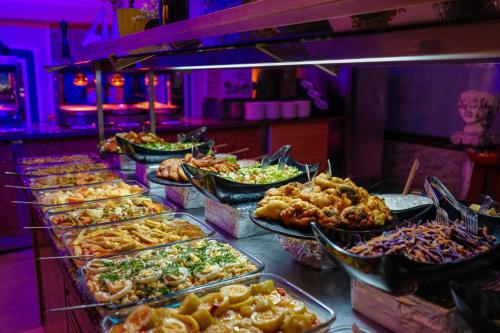 a buffet line with many different types of food at Club Aquarium Hotel & Spa in Guvercinlik