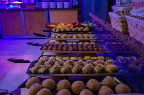 a buffet line with trays of muffins and pastries at Club Aquarium Hotel & Spa in Guvercinlik