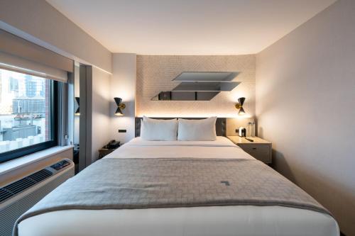 a bedroom with a large bed and a window at Pestana CR7 Times Square in New York