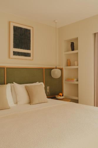 a bedroom with a large bed with white pillows at Aethos Mallorca in Paguera