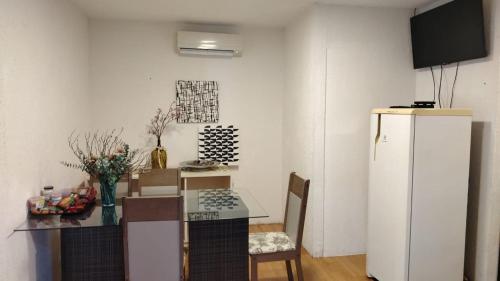 a kitchen with a table and a white refrigerator at Departamento 41 con 2 habitaciones in Ciudad del Este