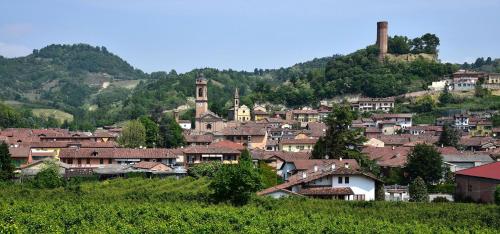 a group of houses on a hill with a town at Palazzo Sismonda in Corneliano d'Alba