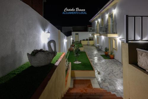 a view of a hallway of a building at night at Casinha Branca in Fundão
