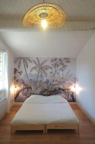 une chambre avec un lit avec un tableau sur le mur dans l'établissement Le Pistoulet, à Saint-Siffret