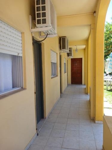 an empty hallway of a building with a door at Hotel Brisas in San Clemente del Tuyú