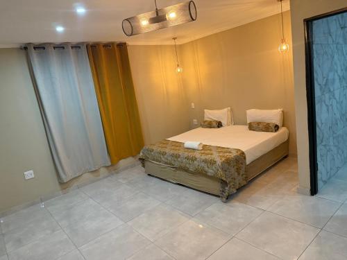 a bedroom with a bed in a room at Horizon Bed and Breakfast in Roodepoort