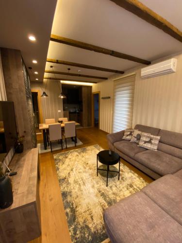 a living room with a couch and a table at Zlatibor Golden Lux Apartment in Zlatibor