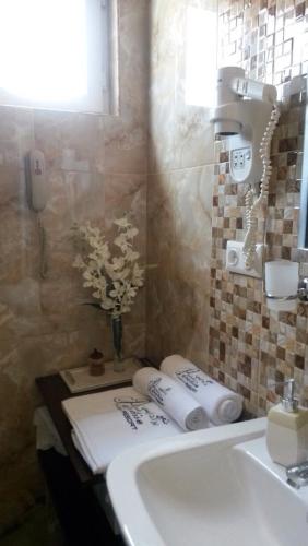 a bathroom with a sink and a counter with towels at Paradise Investment Resort in Tʼelavi