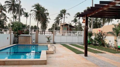 a swimming pool in the backyard of a house at Casa Atlantico Flecheiras in Trairi