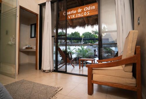 a room with a chair and a sign on the window at Playa Vikingos Tequesquitengo in Cuernavaca