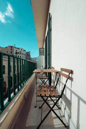 a table and chairs sitting on a balcony at Valguarnera Studio Apartments in Palermo