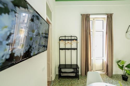 a living room with a table and a window at Valguarnera Studio Apartments in Palermo