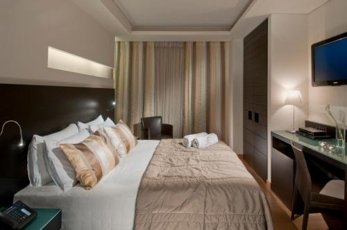 a hotel room with a bed and a desk at O&B Athens Boutique Hotel in Athens