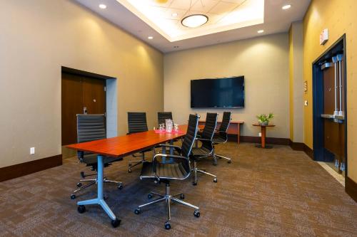 a conference room with a large wooden table and chairs at Grand Park Hotel Vancouver Airport, an Ascend Collection Hotel in Richmond
