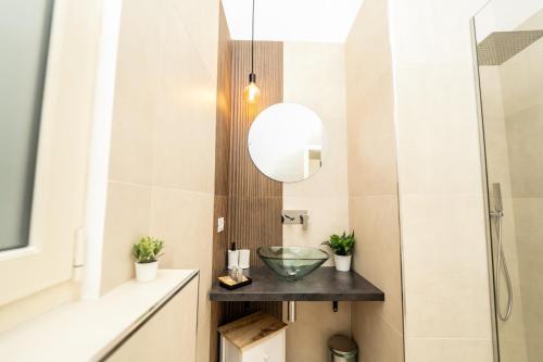 a bathroom with a sink and a mirror at Valguarnera Studio Apartments in Palermo