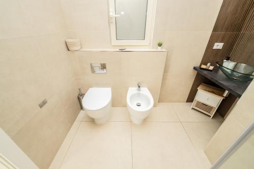 a bathroom with a toilet and a sink at Valguarnera Studio Apartments in Palermo