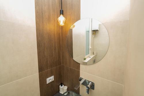 a bathroom with a sink and a mirror at Valguarnera Studio Apartments in Palermo